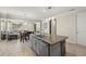 Kitchen island with a stainless steel sink and dishwasher, alongside the dining and living areas at 11499 Renaissance Blvd, Venice, FL 34293