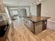 Open kitchen featuring granite countertops and island with a view to the living room at 11499 Renaissance Blvd, Venice, FL 34293