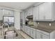 Well-lit kitchen with gray cabinets, stainless steel appliances, and stylish backsplash at 11499 Renaissance Blvd, Venice, FL 34293