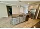Kitchen featuring a granite island with stainless steel appliances and custom cabinets at 11499 Renaissance Blvd, Venice, FL 34293