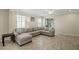 Comfortable living room with tile floors, recessed lights, ceiling fan, and a large sectional sofa at 11499 Renaissance Blvd, Venice, FL 34293