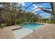 Inviting screened-in pool area with lush landscaping and a tranquil waterfall feature at 11499 Renaissance Blvd, Venice, FL 34293