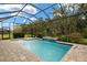 Relaxing screened-in pool with clear blue water and a peaceful outdoor setting at 11499 Renaissance Blvd, Venice, FL 34293