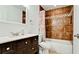 Bathroom featuring dark wood vanity, tiled shower/bath combo, and neutral accents at 1204 25Th W Ave, Palmetto, FL 34221