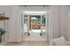 Open French doors to the outdoor dining area and the swimming pool on the back porch at 1208 Oak Hammock Rd, Sarasota, FL 34240