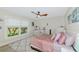 Cozy bedroom featuring a ceiling fan, large window, stylish decor, and neutral colors at 1208 Oak Hammock Rd, Sarasota, FL 34240