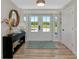 Bright foyer featuring double doors, a modern light fixture, and luxury vinyl plank flooring at 1208 Oak Hammock Rd, Sarasota, FL 34240