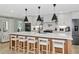 Gourmet kitchen with an island, breakfast bar, stainless steel appliances, and pendant lighting at 1208 Oak Hammock Rd, Sarasota, FL 34240