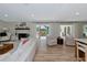 Bright living room with a fireplace, wood floors, and patio doors that lead to a pool at 1208 Oak Hammock Rd, Sarasota, FL 34240