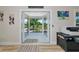 Open living space with access to a balcony, featuring neutral walls and wood floors and an office setup at 1208 Oak Hammock Rd, Sarasota, FL 34240