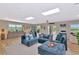 Spacious living room with skylights, neutral walls, a large sectional couch and a view of the outdoors at 1208 Oak Hammock Rd, Sarasota, FL 34240