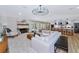 Comfortable living room features a fireplace, modern chandelier, and an open layout to the kitchen at 1208 Oak Hammock Rd, Sarasota, FL 34240