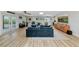 Spacious living room with light wood floors, comfortable seating, and lots of natural light at 1208 Oak Hammock Rd, Sarasota, FL 34240