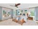 Serene main bedroom with a king bed, bench, and light blue accents, with patio access to a pool at 1208 Oak Hammock Rd, Sarasota, FL 34240