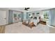 Spacious main bedroom with modern decor, light wood floors and access to the pool and backyard at 1208 Oak Hammock Rd, Sarasota, FL 34240