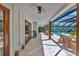 Spacious covered patio features a dining area, lounge furniture, ceiling fan, and view of the pool at 1208 Oak Hammock Rd, Sarasota, FL 34240