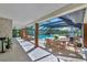 Covered outdoor pool area with dining and lounge seating, perfect for relaxation and entertainment at 1208 Oak Hammock Rd, Sarasota, FL 34240