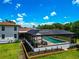 A luxurious screened-in pool area offering private relaxation and entertainment space with an adjacent well-manicured lawn at 1208 Oak Hammock Rd, Sarasota, FL 34240