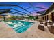 Screened pool with lounge chairs and outdoor dining area offers a perfect outdoor living space at 1208 Oak Hammock Rd, Sarasota, FL 34240