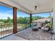Outdoor living space with comfortable seating, a ceiling fan, and scenic views of the surrounding landscape at 1208 Oak Hammock Rd, Sarasota, FL 34240