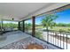 Inviting outdoor living space with ceiling fan, comfortable seating, and picturesque views of the surrounding greenery at 1208 Oak Hammock Rd, Sarasota, FL 34240