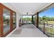 Inviting outdoor living space with ceiling fan, comfortable seating, and picturesque views of the surrounding nature at 1208 Oak Hammock Rd, Sarasota, FL 34240