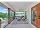 Inviting outdoor living space with comfortable seating, a ceiling fan, and a view of the property landscape at 1208 Oak Hammock Rd, Sarasota, FL 34240