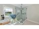 Spa like glass enclosed shower with pebble floor and hand held shower head at 1208 Oak Hammock Rd, Sarasota, FL 34240