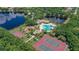 Aerial view of community amenities including pool, tennis courts, playground and lake at 12810 Kite Dr, Bradenton, FL 34212