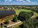 Beautiful aerial view of the community featuring a lake, walking path, playground, and manicured lawns at 12810 Kite Dr, Bradenton, FL 34212
