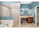 This bathroom has a glass-enclosed shower, vanity with a makeup area, and tan tile at 12810 Kite Dr, Bradenton, FL 34212