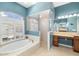 Bathroom featuring a separate shower, tub, and vanity with natural light at 12810 Kite Dr, Bradenton, FL 34212