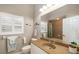 Neutral bathroom with a single sink vanity, toilet, and shower/tub combo with decorative fish on the wall at 12810 Kite Dr, Bradenton, FL 34212
