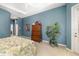 Spacious main bedroom featuring a tray ceiling, carpeted floor, and a tropical plant at 12810 Kite Dr, Bradenton, FL 34212