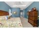 Cozy bedroom with a king bed, dresser, and neutral carpet, offering comfort and tranquility at 12810 Kite Dr, Bradenton, FL 34212