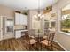 Cozy breakfast nook featuring a glass table, striped chairs, and natural light from the window at 12810 Kite Dr, Bradenton, FL 34212