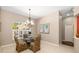 Bright dining room featuring a glass table, chandelier, and large windows at 12810 Kite Dr, Bradenton, FL 34212