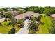 Beautiful home boasts lush landscaping, a tile roof, and a spacious driveway at 12810 Kite Dr, Bradenton, FL 34212