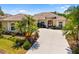 Beautiful home with a tile roof, well-kept lawn, and elegant front entry with columns at 12810 Kite Dr, Bradenton, FL 34212