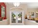 Light and bright entry foyer featuring a double-door entry and transom windows at 12810 Kite Dr, Bradenton, FL 34212