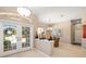 Bright foyer with double doors and tiled flooring leading to dining area at 12810 Kite Dr, Bradenton, FL 34212