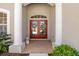 Elegant double front doors framed by grand pillars and manicured landscaping at 12810 Kite Dr, Bradenton, FL 34212