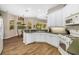 Bright kitchen featuring white cabinetry, stainless steel appliances, and plenty of counter space at 12810 Kite Dr, Bradenton, FL 34212