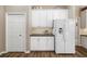 Efficient kitchen design with white cabinets, modern refrigerator, and ample storage space at 12810 Kite Dr, Bradenton, FL 34212