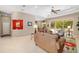 Bright living room with tile floors, cozy sofas, and sliding glass doors leading to the pool area at 12810 Kite Dr, Bradenton, FL 34212
