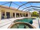 Relax in this screened-in pool and spa surrounded by an expansive deck and lush greenery at 12810 Kite Dr, Bradenton, FL 34212