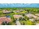 Neighborhood view showing homes with tropical landscaping and a serene waterway behind this house at 12822 Kite Dr, Bradenton, FL 34212