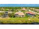 Aerial view of the rear of this real estate showing mature trees, a waterway, and a fenced-in pool at 12822 Kite Dr, Bradenton, FL 34212