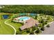 Aerial view highlighting the community pool, tennis courts, and surrounding green landscape at 12822 Kite Dr, Bradenton, FL 34212