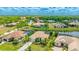 Neighborhood view of homes with tropical landscaping and nearby waterways and green spaces at 12822 Kite Dr, Bradenton, FL 34212